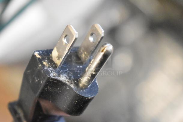 Close-up of a three-prong plug from a Hamilton Beach HMD400 metal countertop drink mixer, showing wear.