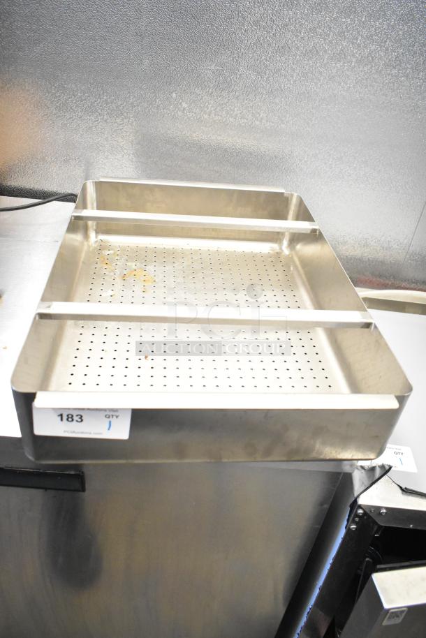 Stainless steel sink bay strainer insert, perforated design, rectangular shape, used condition, with item tag number 183.