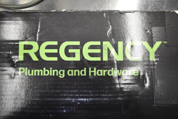 "Regency Plumbing and Hardware" box with some scratches and dents, indicating new but imperfect condition.