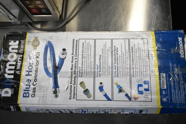 Brand new Dormont 16100KIT48 gas connector kit with blue hose, SnapFast® fittings, and restraining cable. Box shows wear.