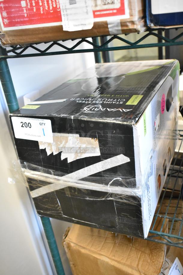 Boxed AvaMix 928CJ1400 electric citrus juicer, stainless steel, 120V, new with scratches and dents, visible labels.