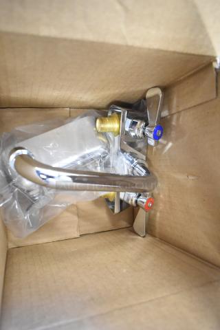 Brand new metal faucet in box, chrome finish, visible scratch and dent, marked hot and cold handles.