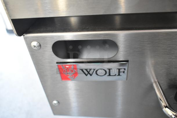 Brand new Wolf 950AGM72N stainless steel griddle, natural gas, 162,000 BTU, with visible logo badge, scratch and dent condition.