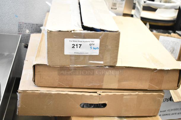 Boxes containing 3 brand new scratch and dent items, including a water bottle filling attachment. Label shows auction item 217, quantity 3.
