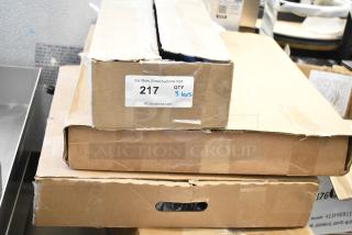 Boxes containing 3 brand new scratch and dent items, including a water bottle filling attachment. Label shows auction item 217, quantity 3.
