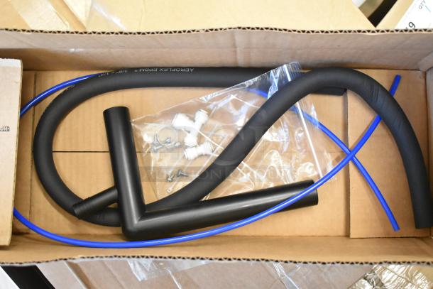 Box with three brand new scratch and dent water bottle filling attachment items, including hoses and connectors.