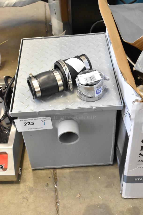 Brand new Zurn GT2700-07-2NH grease trap, 14 lb., 7 GPM, 2" No-Hub connections, minor cosmetic scratches, NSF certified label.