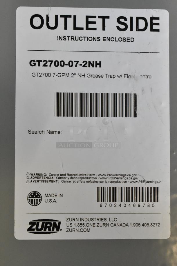 Brand new Zurn GT2700-07-2NH grease trap, 14 lb. capacity, 7 GPM, 2" no-hub connections, outlet side label.