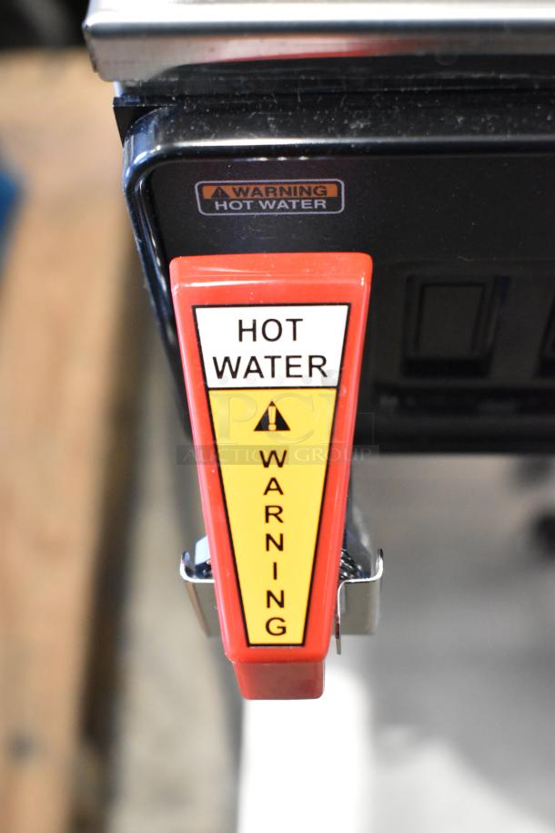 Bunn CWTF15-APS coffee brewer, stainless steel, warning label on hot water faucet, 120 volts, new, minor scratches.