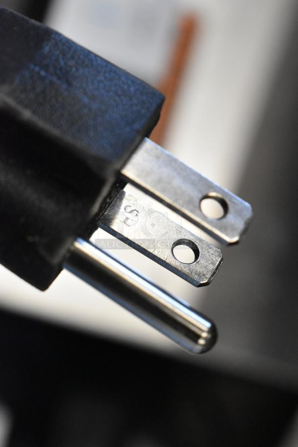 Alt text: Close-up of a power plug for the Bunn CWTF15-APS coffee brewer, showing the prongs and plug detail.