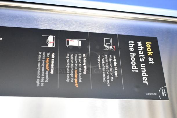 Alt Text: SimpleHuman 12-gallon stainless steel butterfly step can with instructional label on lid, brand new with minor scratches.