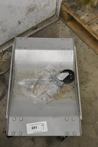 Brand new metal dolly with commercial casters, scratch and dent condition. Features a sticker with auction site details.