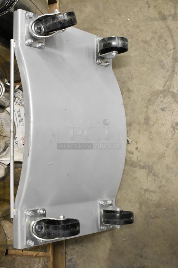 Brand new metal dolly with commercial casters, minor scratches. Durable construction, ideal for heavy-duty use.