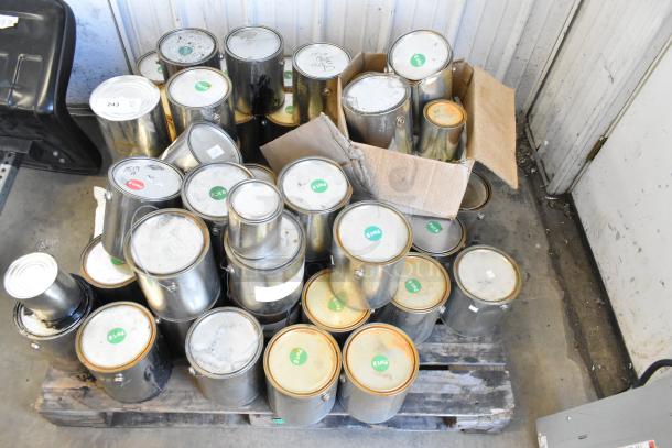 40 Pro Guard chemical cans, including Fire Brick Road EPDM Rubber, Trilene, stacked on pallets, various sizes, labels visible.