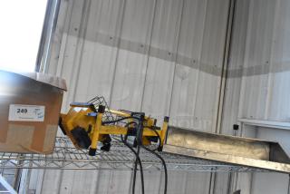 Alt text: Tier lot including yellow work light and box labeled "249 QTY Tier Lot" on a metal shelf.