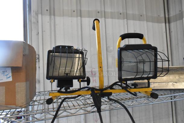 Tier lot including two yellow portable work lights with mesh guards and a labeled box reading "QTY Tier 1 lot."