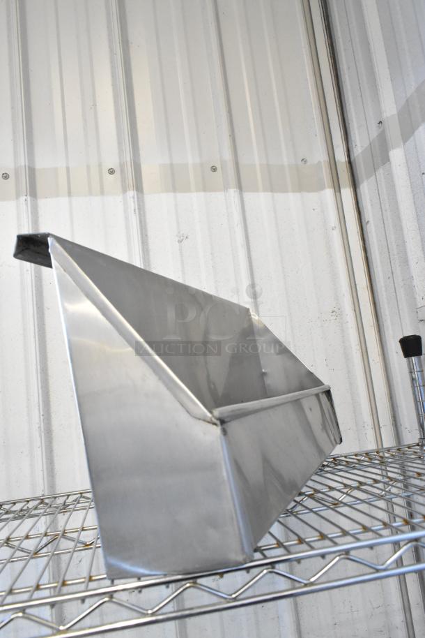 Metal storage bin on a wire shelf, angled view. Part of an auction lot including a work light and Speedwell items.