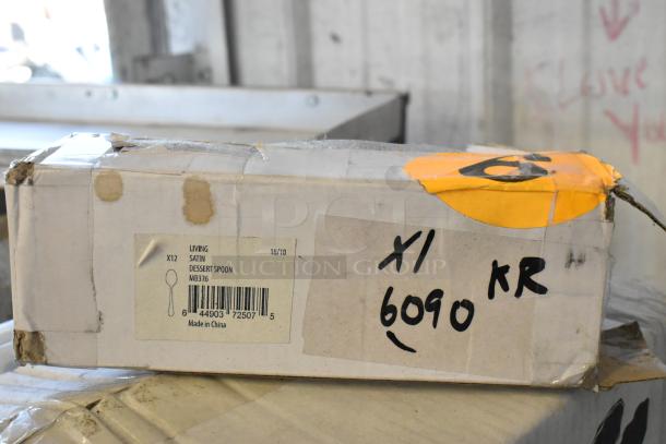 Box with "Living Satin Dessert Spoon MB336" label, barcode, and "Made in China." Marked with "X1 KR 6090" and an orange tag. Box shows wear.