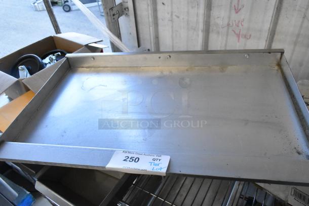 ALL ONE MONEY! Tier Lot including various items: serving tongs, dice, metal pieces, commercial casters, MyZone MZ-3 band. Visible tag marked "250 QTY Tier Lot."