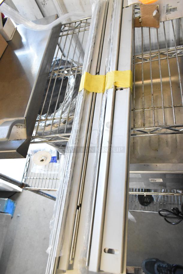 Lot of miscellaneous items including metal pieces, commercial casters, MyZone MZ-3 band, dice, and serving tongs.