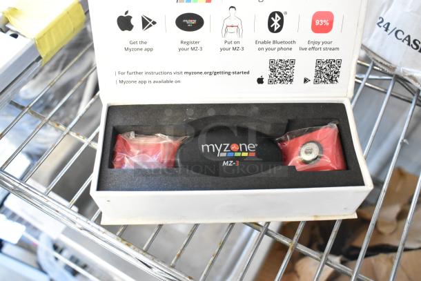 MyZone MZ-3 Band in box, features heart rate monitoring technology, includes setup instructions and logos, in good condition.