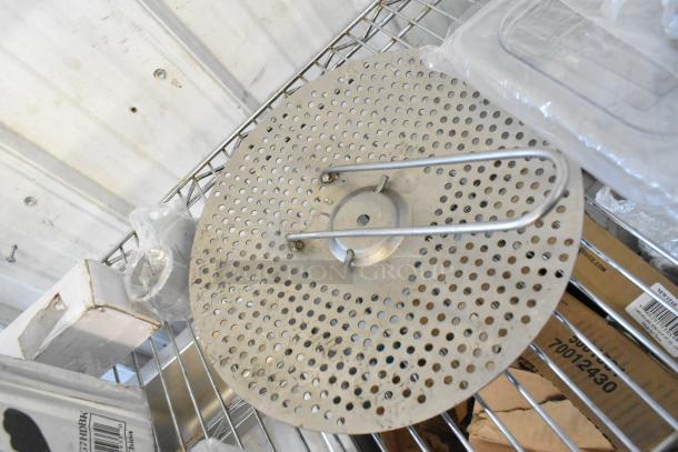 Perforated metal piece on wire shelf, included in tier lot with dice, tongs, casters, and MyZone MZ-3 Band.