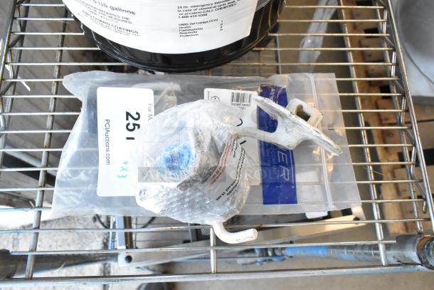 3-item bundle: dough hook attachment, Fisher 10863 jet spray in packaging, GR-133A gas connector piece, wrapped, on metal rack.