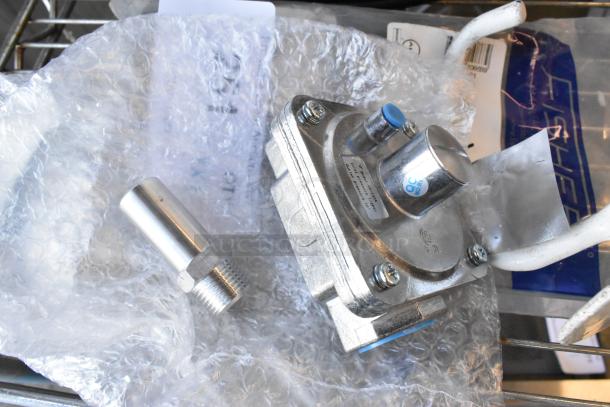 Three items including a dough hook attachment, Fisher 10863 jet spray, and GR-133A gas connector piece in packaging.