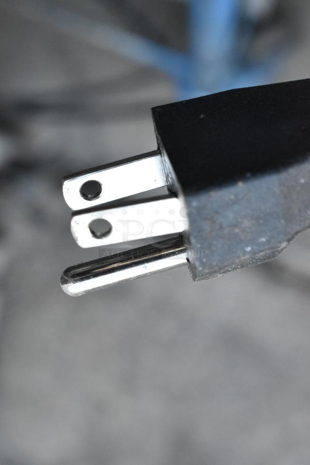 Close-up of a three-prong plug belonging to a Patton PUH9907HD room heater. Appears in functional condition. 120 volts, 1 phase.