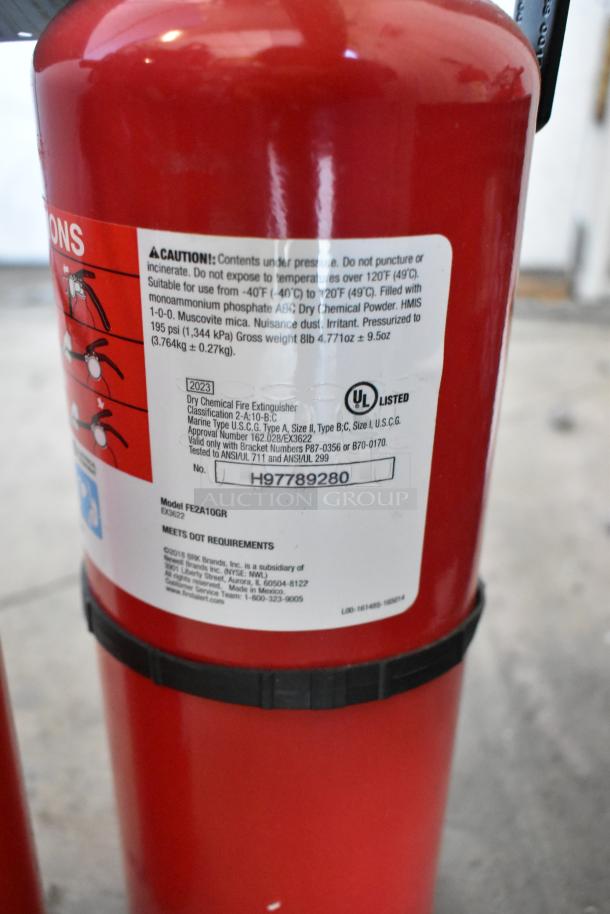 Red ABC dry chemical fire extinguisher, model FE2A10GR, labeled with safety instructions and UL certification.