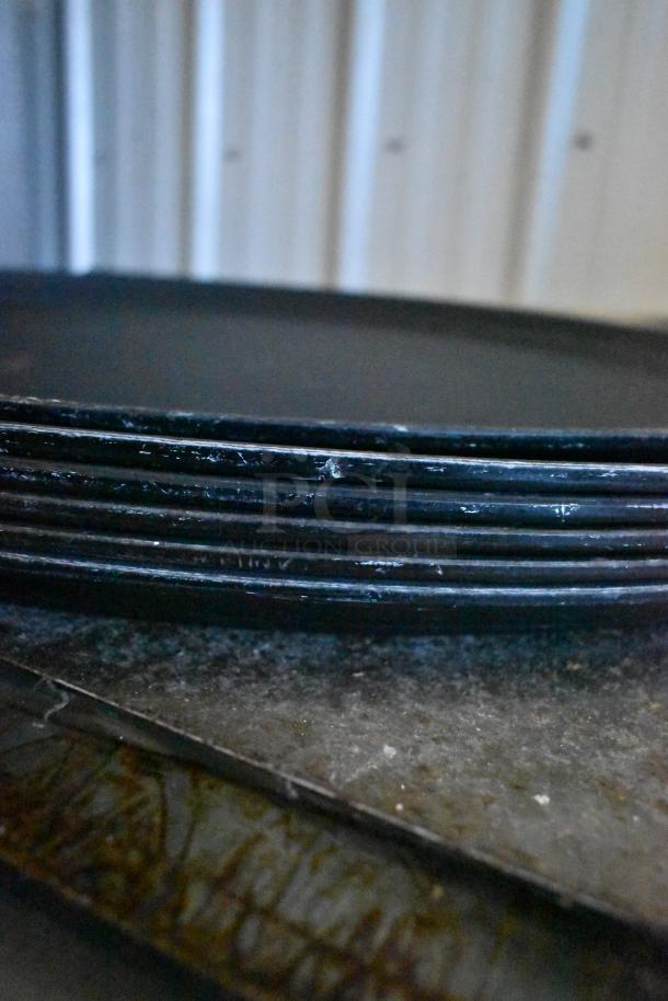 8 various items including metal serving trays and pizza peel, with signs of wear. Auction lot offers 8 times your bid.