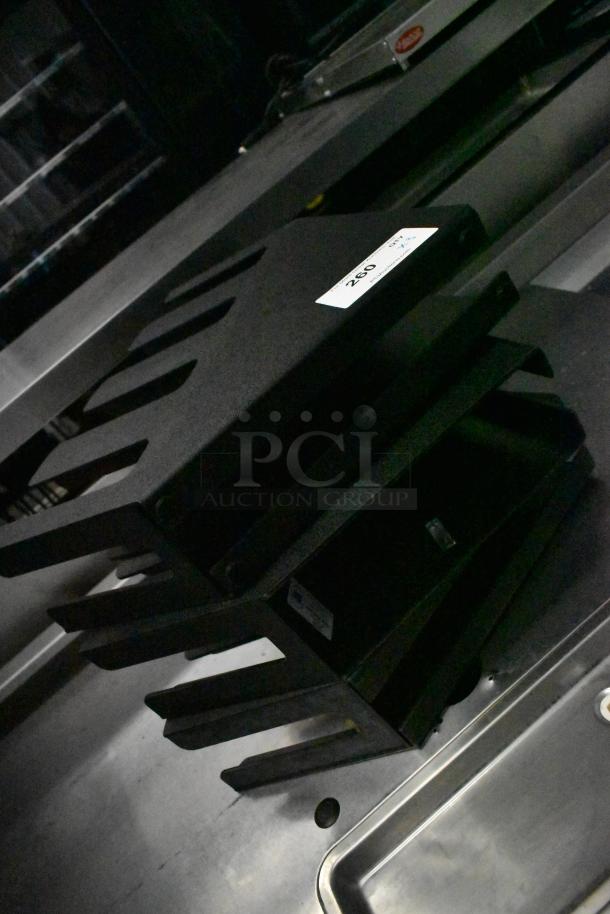 3 LID-4STAR black poly lid dispensers, stackable design. Includes visible label with item number 260. Appears in good condition.