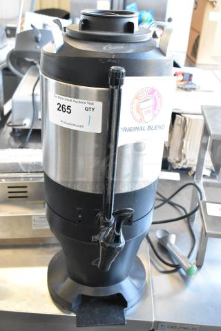 Curtis TXSG1501S600 stainless steel beverage dispenser, featuring durable construction, tap spout, and Dunkin' label.