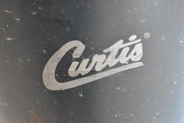 Curtis TXSG1501S600 stainless steel beverage holder, used, visible brand logo, minor surface wear.