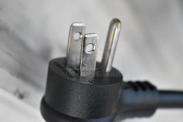 Close-up view of a three-prong plug, part of a True TSCI-600R-G-PH commercial cooler.