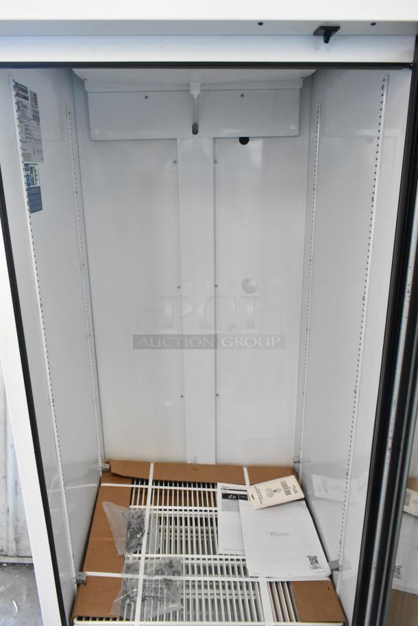 True TSCI-600R-G-PH single door cooler, brand new, poly-coated racks, tags visible, 115V, minor scratches and dents.