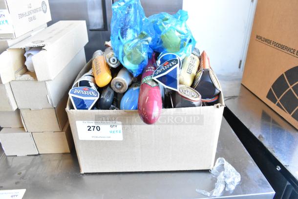 Box of 55 diverse beer tap handles, including Samuel Adams, showing collectible styles and brands.