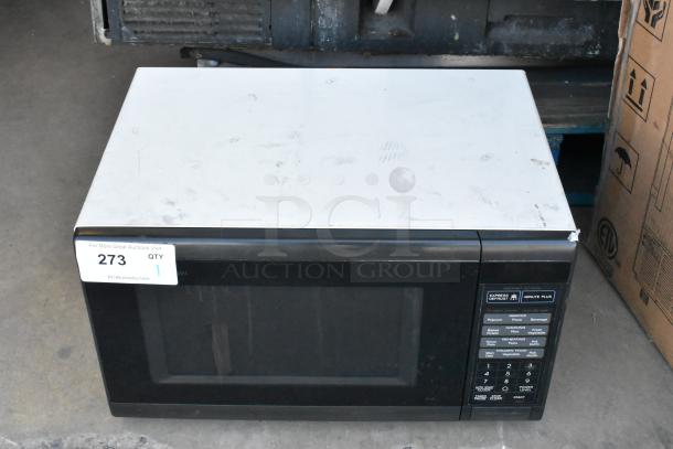 Sharp R-3A55 countertop microwave oven with plate, 120 volts, 1 phase, visible wear on top surface, control panel intact.