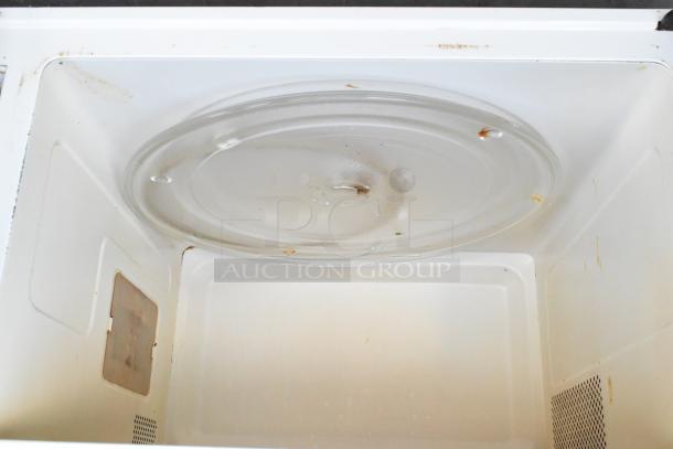 Sharp R-3A55 microwave interior with glass plate visible, showing signs of use, 120V, 1 phase.
