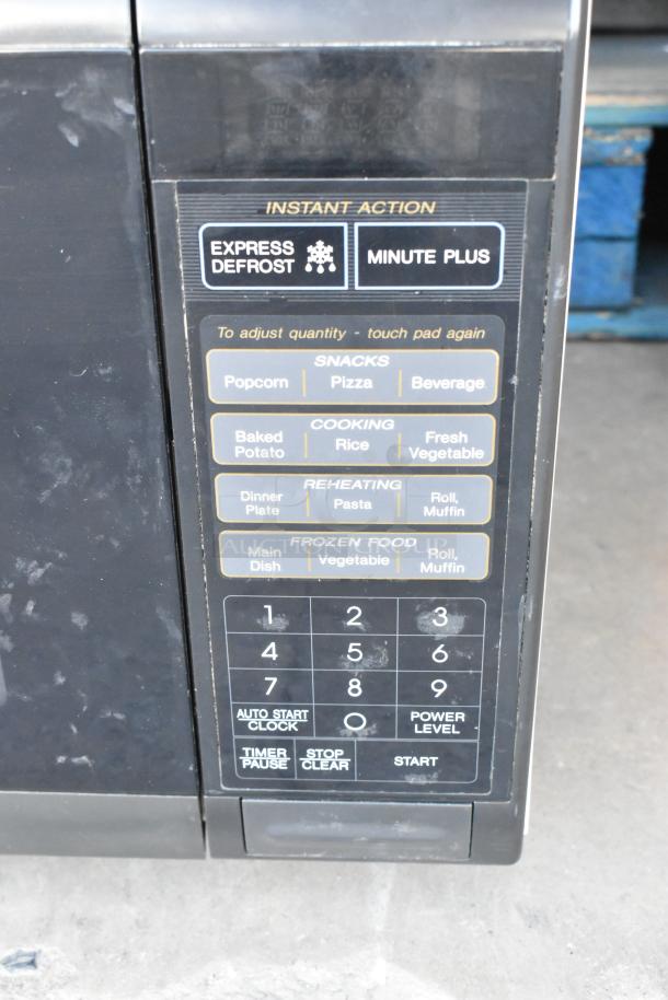 Sharp R-3A55 countertop microwave oven with keypad. Features 120 volts, 1 phase. Includes plate, minor wear visible.