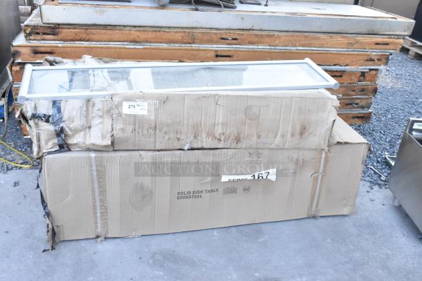 Brand new 600DDT60L 5' soiled dish table with left drainboard and glass pane. Scratch and dent condition. Box labeled.
