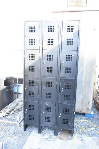 Black metal 12 cubby locker with vented doors, showing moderate wear, suitable for industrial or garage use.