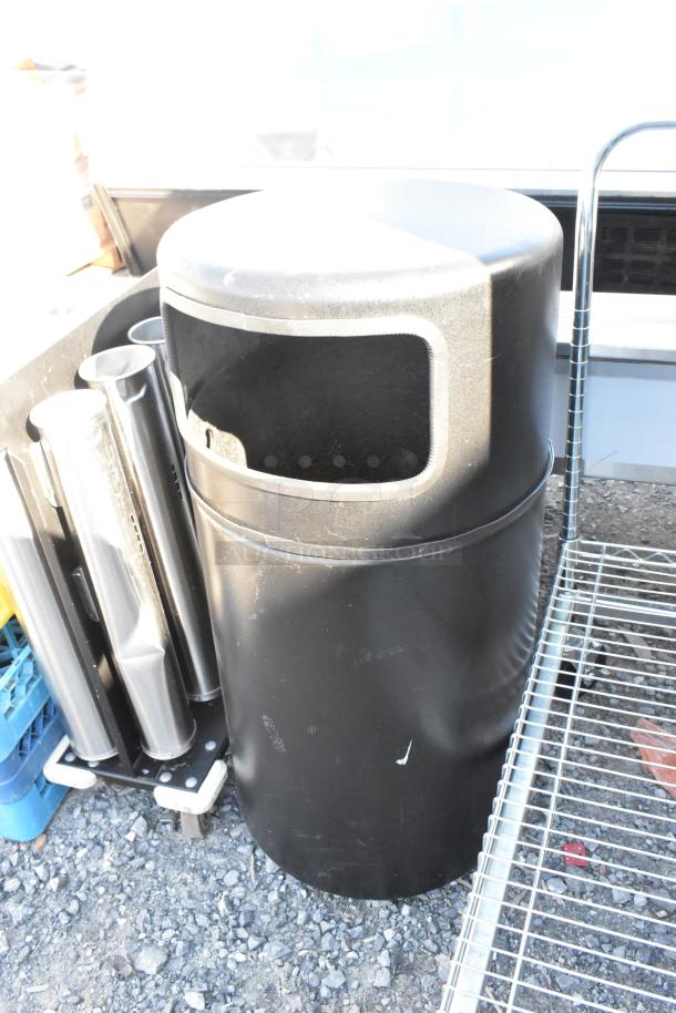 Black trash can shell, cylindrical design, surface scratches, open top mouth, suitable for outdoor use.