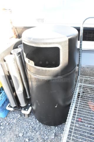 Black trash can shell, cylindrical design, surface scratches, open top mouth, suitable for outdoor use.