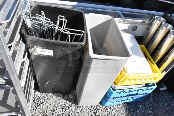 Lot includes poly glass racks, gray Slim Jim trash can, metal hooks container with tags, and colored plastic crates.