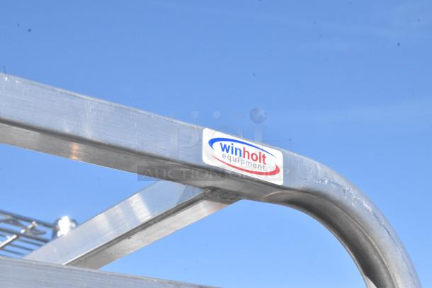 Metal commercial pan transport rack with Winholt Equipment label, features sturdy steel frame and commercial casters for mobility.