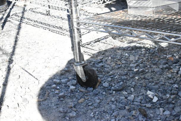 Chrome 4-tier wire shelving unit with contents, on commercial casters. Buyer must dismantle. Consider freight charges.