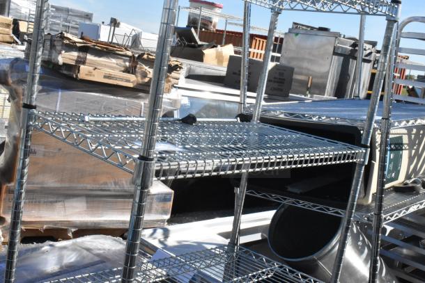 Chrome finish 5 tier wire shelving unit in good condition, requires dismantling. Consider freight for shipping.