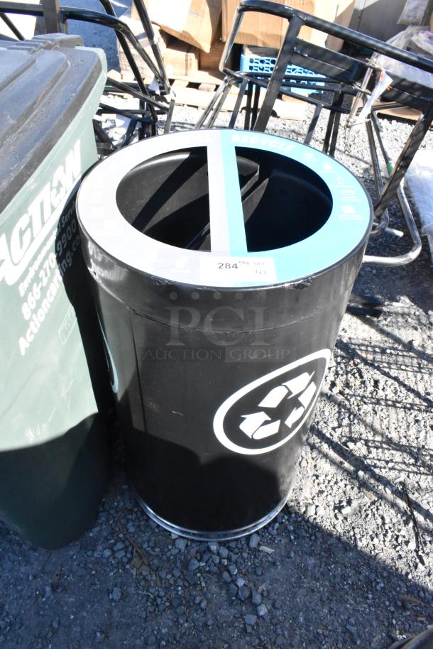 Black recycling trash can shell, round with blue rim, recycle symbol, label "2 Times Your Bid," slightly worn condition.