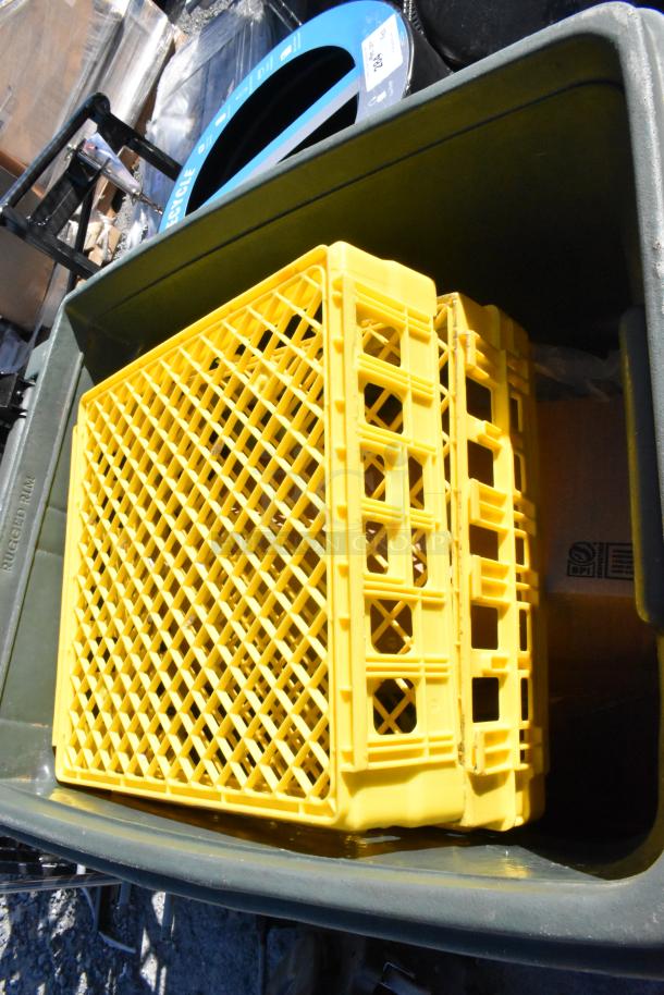 Green trash can with yellow plastic crates inside, marked "Rugged Rim." Contents included. Used condition.
